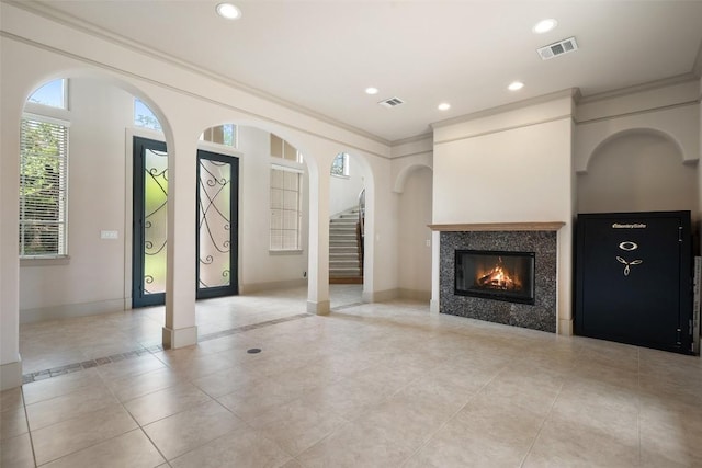 7800 Aspen Highlands Dr, Austin, TX 78746 - unfurnished living room featuring ornamental molding, tile patterned floors, stairway, a tile fireplace, and recessed lighting