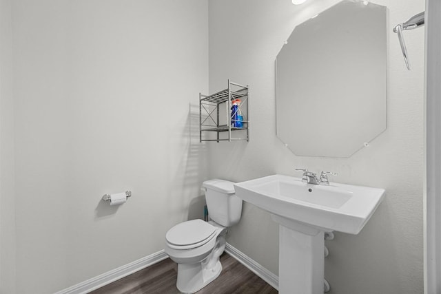 7901 Donnelley Dr, Austin, TX 78744 - bathroom with toilet, wood finished floors, and baseboards