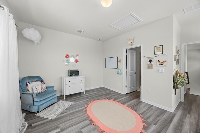 7901 Donnelley Dr, Austin, TX 78744 - recreation room with baseboards, visible vents, and wood finished floors