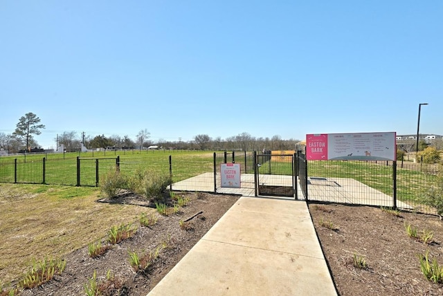 7901 Donnelley Dr, Austin, TX 78744 - view of gate with fence, a rural view, and a yard