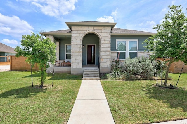 7901 Donnelley Dr, Austin, TX 78744 - view of front of home featuring fence, a porch, a front lawn, and stone siding
