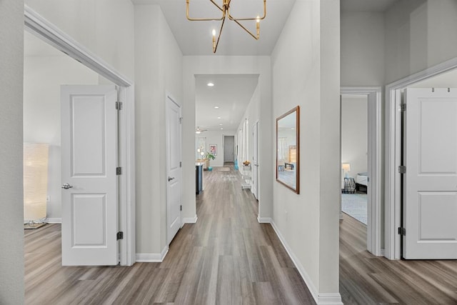 7901 Donnelley Dr, Austin, TX 78744 - hallway with wood finished floors, recessed lighting, a chandelier, and baseboards