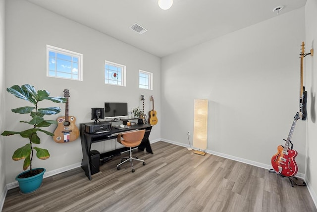 7901 Donnelley Dr, Austin, TX 78744 - office area with baseboards, visible vents, and wood finished floors