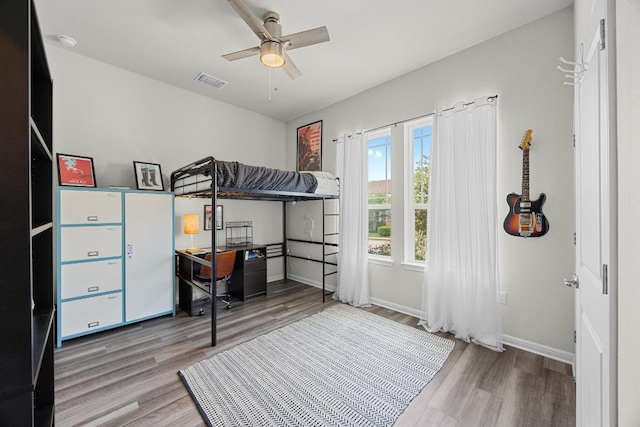 7901 Donnelley Dr, Austin, TX 78744 - bedroom with a ceiling fan, visible vents, wood finished floors, and baseboards
