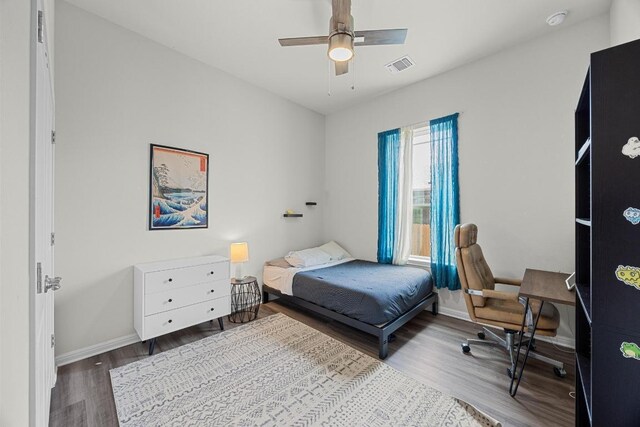 7901 Donnelley Dr, Austin, TX 78744 - bedroom featuring baseboards, visible vents, wood finished floors, and a ceiling fan