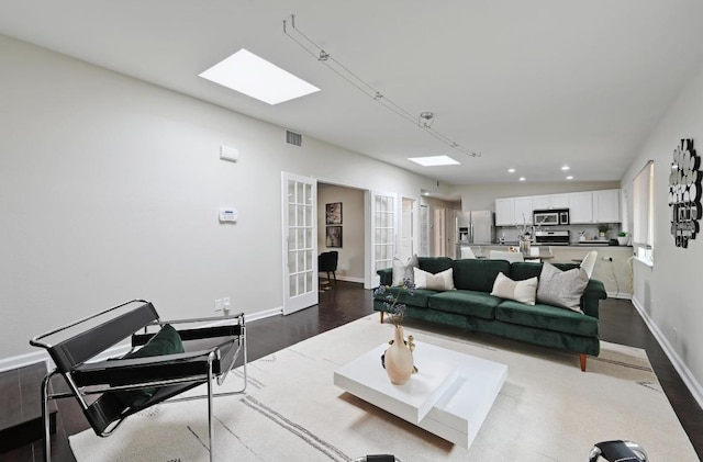 2115 Ann Arbor Ave Unit B, Austin, TX 78704 - living area with dark wood-type flooring, french doors, baseboards, and recessed lighting