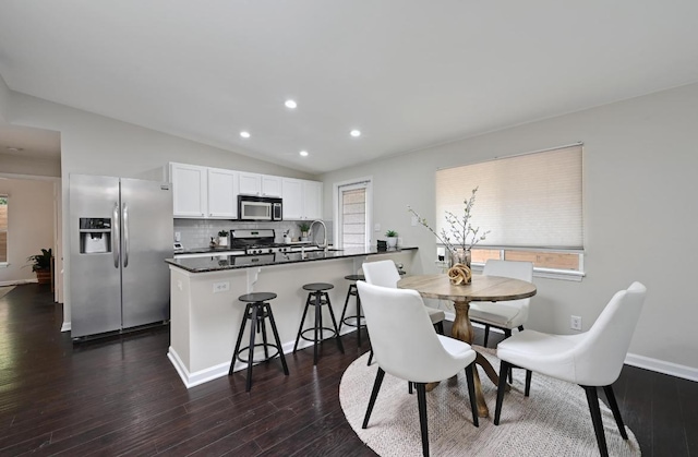 2115 Ann Arbor Ave Unit B, Austin, TX 78704 - dining area featuring vaulted ceiling, dark wood-style flooring, recessed lighting, plenty of natural light, and baseboards