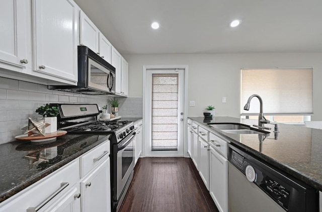 2115 Ann Arbor Ave Unit B, Austin, TX 78704 - kitchen with a sink, stainless steel appliances, dark stone countertops, white cabinetry, and dark wood-type flooring