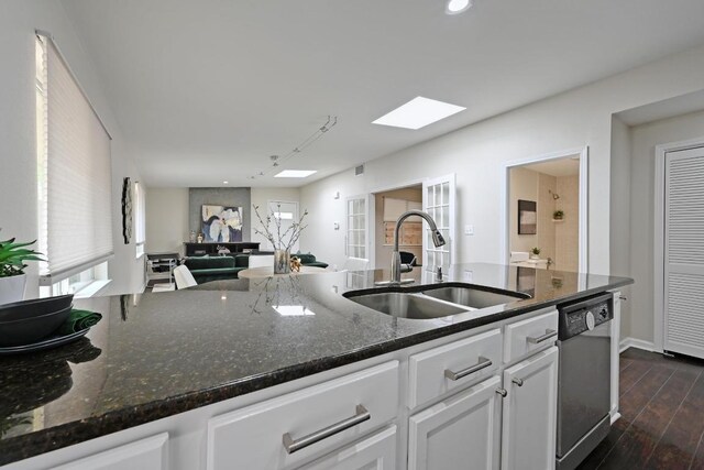 2115 Ann Arbor Ave Unit B, Austin, TX 78704 - kitchen featuring stainless steel dishwasher, a sink, white cabinetry, open floor plan, and dark wood-style flooring