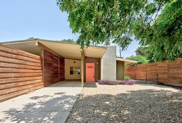 2115 Ann Arbor Ave Unit B, Austin, TX 78704 - view of front of property with stucco siding, concrete driveway, and an attached carport