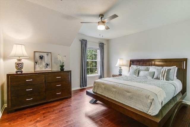 bedroom featuring baseboards, ceiling fan, lofted ceiling, and dark wood-type flooring