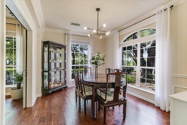 dining space with visible vents, ornamental molding, a notable chandelier, and dark wood-type flooring