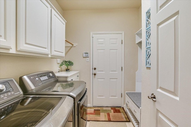 washroom featuring cabinet space and washing machine and clothes dryer