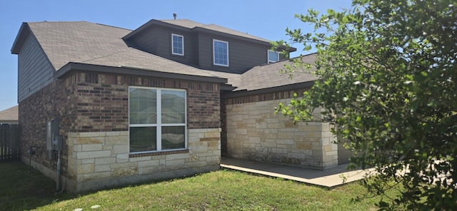 1337 Violet Ln, Kyle, TX 78640 - view of property exterior with stone siding, a shingled roof, and fence