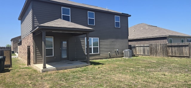 1337 Violet Ln, Kyle, TX 78640 - rear view of house featuring a fenced backyard, a yard, brick siding, central air condition unit, and a patio area