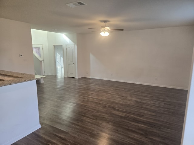1337 Violet Ln, Kyle, TX 78640 - unfurnished living room with a ceiling fan, dark wood-style flooring, and baseboards