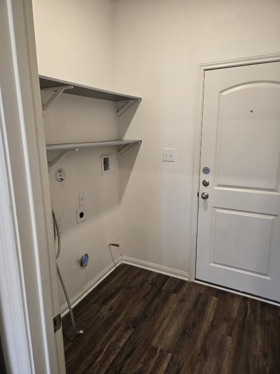 1337 Violet Ln, Kyle, TX 78640 - laundry area featuring hookup for a gas dryer, laundry area, dark wood-type flooring, electric dryer hookup, and baseboards