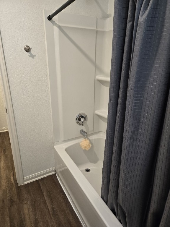 1337 Violet Ln, Kyle, TX 78640 - full bath with shower / tub combo, wood finished floors, and baseboards