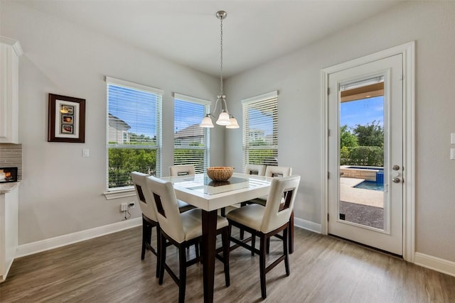 1728 Siena Sunset Rd, Leander, TX 78641 - dining area with wood finished floors, baseboards, and a chandelier