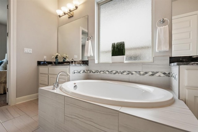 1728 Siena Sunset Rd, Leander, TX 78641 - full bathroom with vanity, baseboards, and a bath