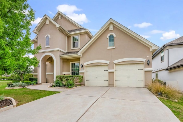 1728 Siena Sunset Rd, Leander, TX 78641 - view of front facade with stucco siding, concrete driveway, a garage, and a front yard