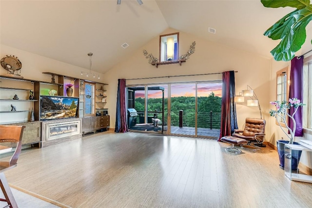 611 N Cuernavaca Dr Unit 301, Austin, TX 78733 - living room with high vaulted ceiling, wood finished floors, and a glass covered fireplace