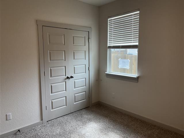 interior space with carpet and baseboards