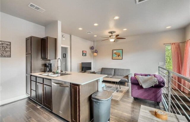 kitchen featuring open floor plan, visible vents, dishwasher, and a sink