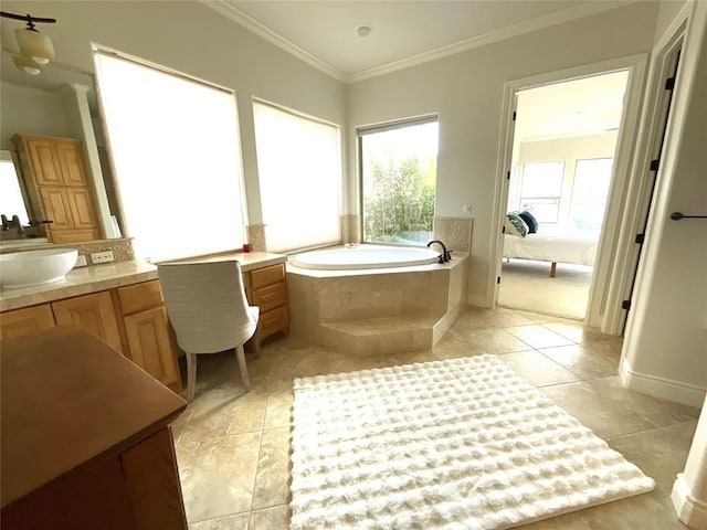 ensuite bathroom with a garden tub, crown molding, tile patterned flooring, baseboards, and vanity