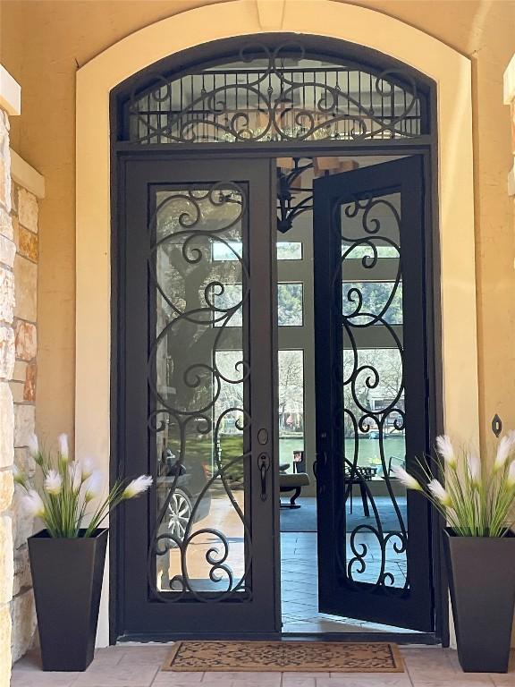 entrance to property featuring a gate and stone siding
