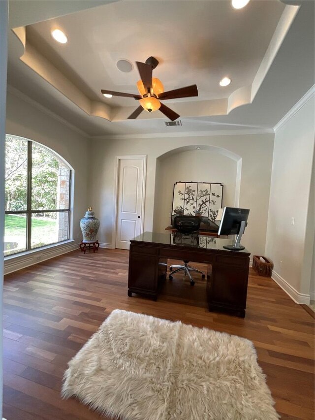 office space featuring visible vents, baseboards, wood finished floors, and a tray ceiling