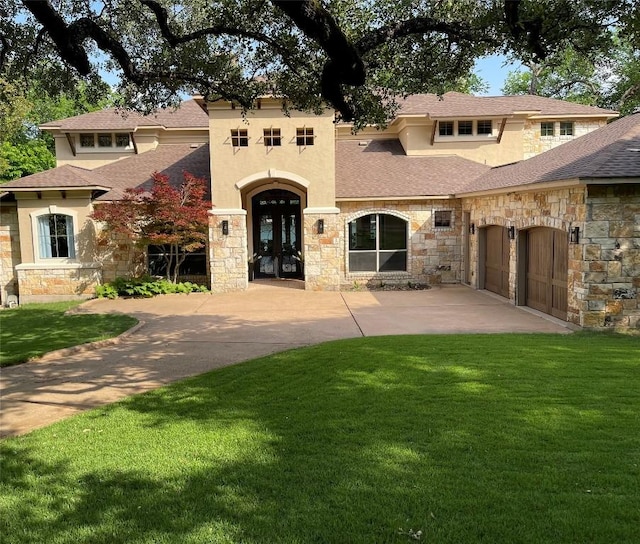 mediterranean / spanish-style home featuring a front lawn, stone siding, and concrete driveway