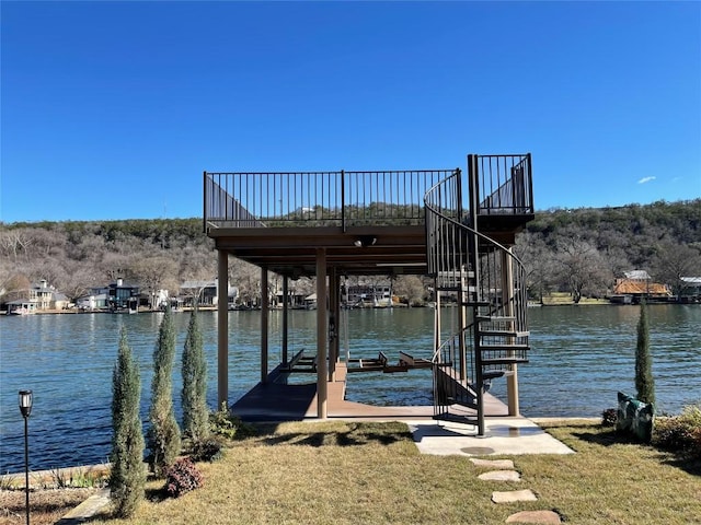 view of dock featuring a deck with water view, a yard, and stairway