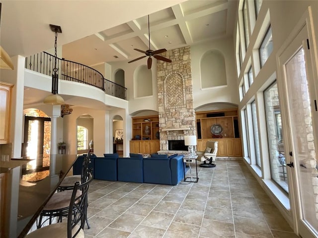 3113 Ski Shores Ter, Austin, TX 78730 - living area with a towering ceiling, a ceiling fan, coffered ceiling, beam ceiling, and decorative columns