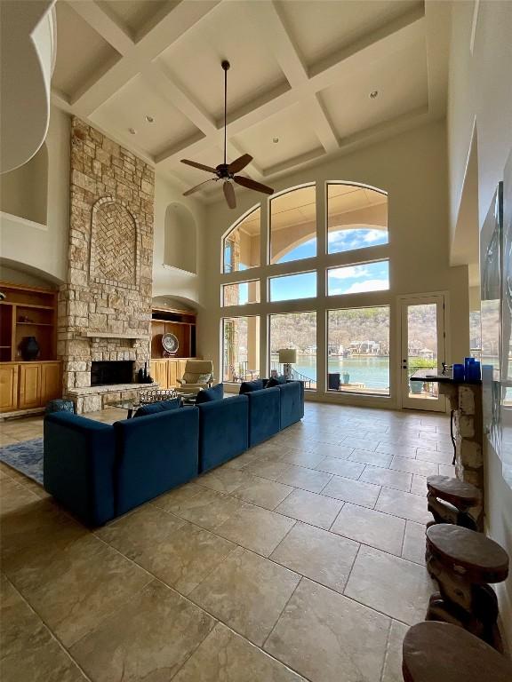 3113 Ski Shores Ter, Austin, TX 78730 - living room featuring coffered ceiling, ceiling fan, a high ceiling, a fireplace, and beamed ceiling