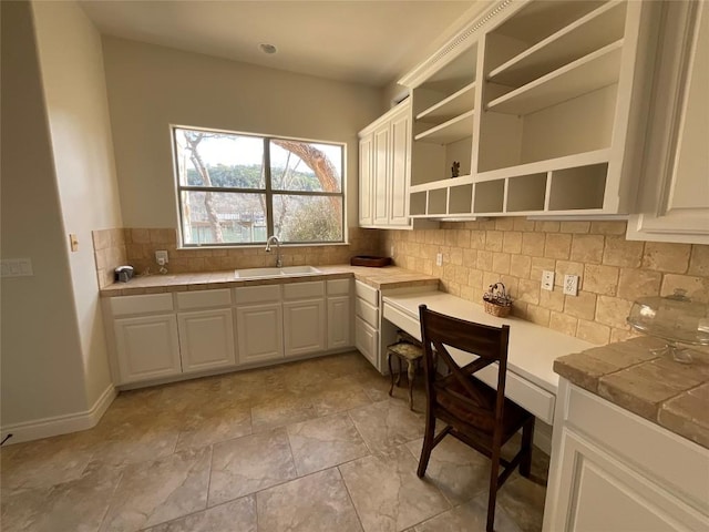 3113 Ski Shores Ter, Austin, TX 78730 - kitchen featuring a sink, tile countertops, decorative backsplash, open shelves, and white cabinetry
