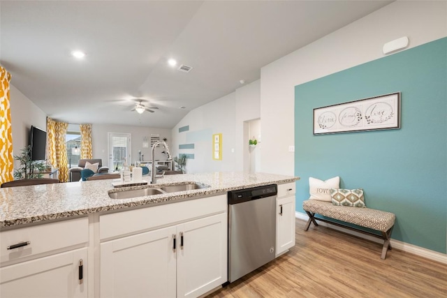 kitchen with light stone counters, ceiling fan, dishwasher, and a sink