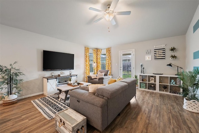living room with wood finished floors, ceiling fan, and baseboards