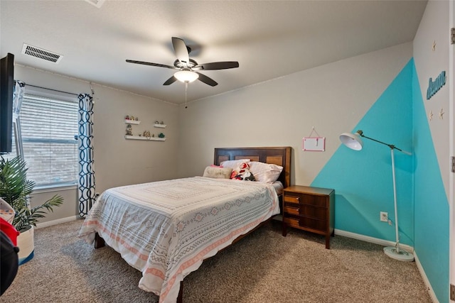 carpeted bedroom featuring a ceiling fan, visible vents, and baseboards
