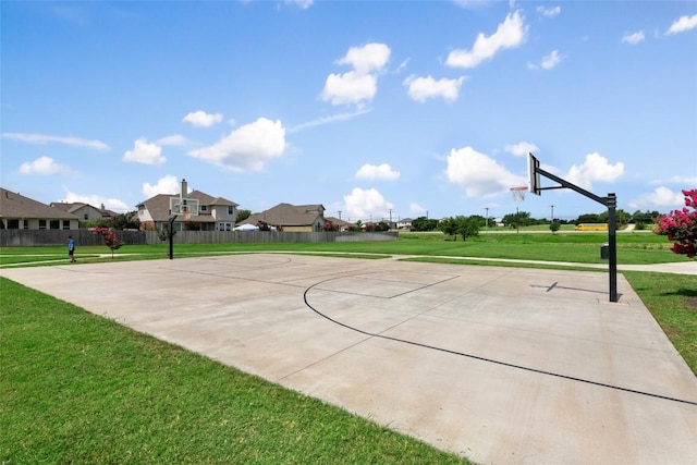 view of sport court featuring a residential view, a lawn, community basketball court, and fence