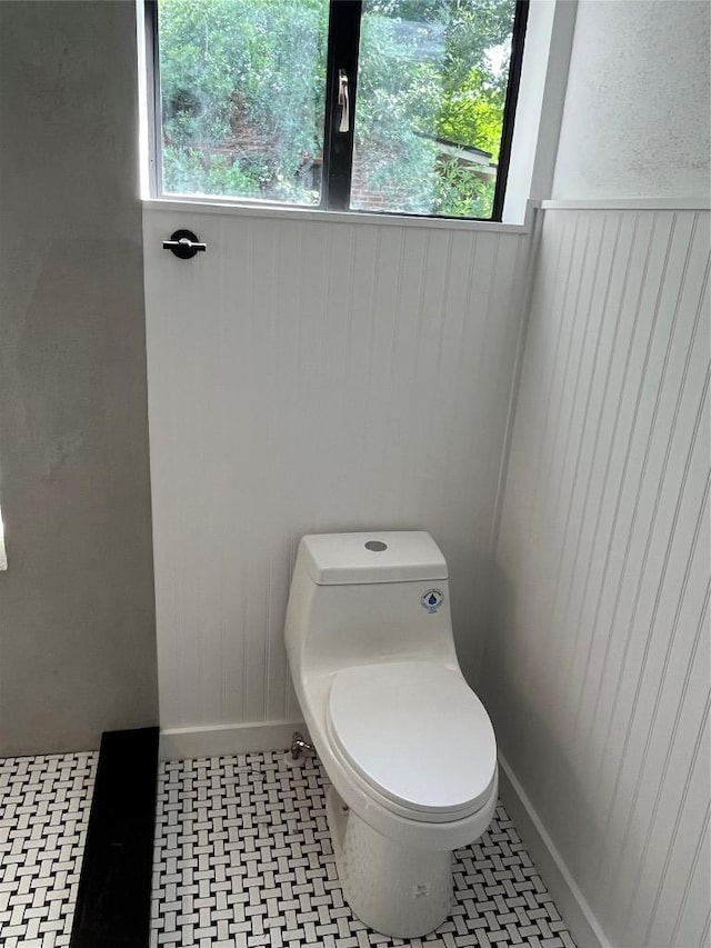 5611 Joe Sayers Ave, Austin, TX 78756 - bathroom featuring toilet, wooden walls, and baseboards