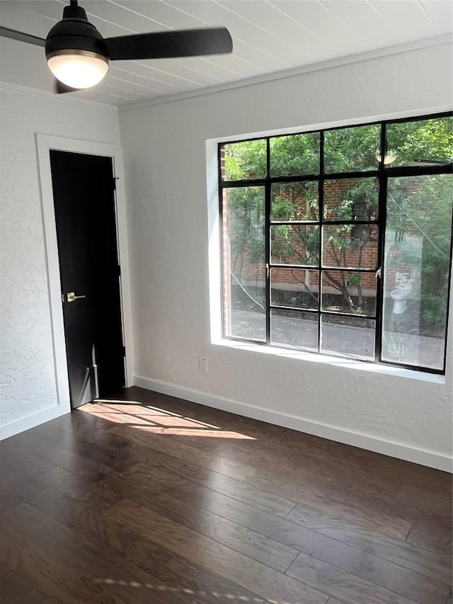 5611 Joe Sayers Ave, Austin, TX 78756 - empty room featuring baseboards, dark wood-type flooring, a textured wall, and ceiling fan