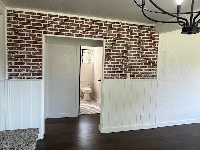 5611 Joe Sayers Ave, Austin, TX 78756 - hallway with dark wood-type flooring, baseboards, and a wainscoted wall