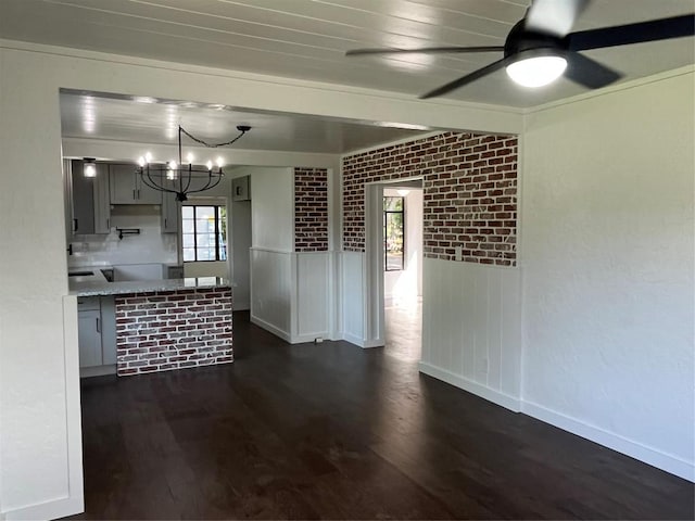 5611 Joe Sayers Ave, Austin, TX 78756 - kitchen with dark wood-style floors, a ceiling fan, a chandelier, and baseboards