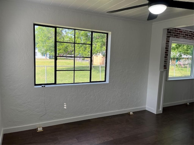 5611 Joe Sayers Ave, Austin, TX 78756 - unfurnished room with a textured wall, a ceiling fan, dark wood finished floors, baseboards, and ornamental molding