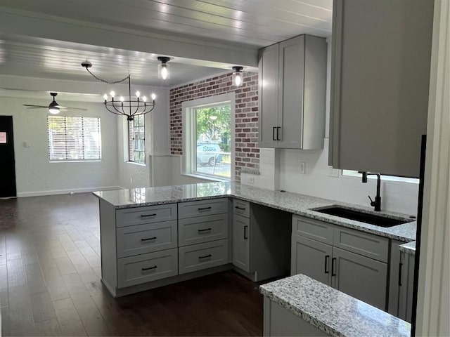 5611 Joe Sayers Ave, Austin, TX 78756 - kitchen featuring a sink, a peninsula, plenty of natural light, and dark wood-style flooring