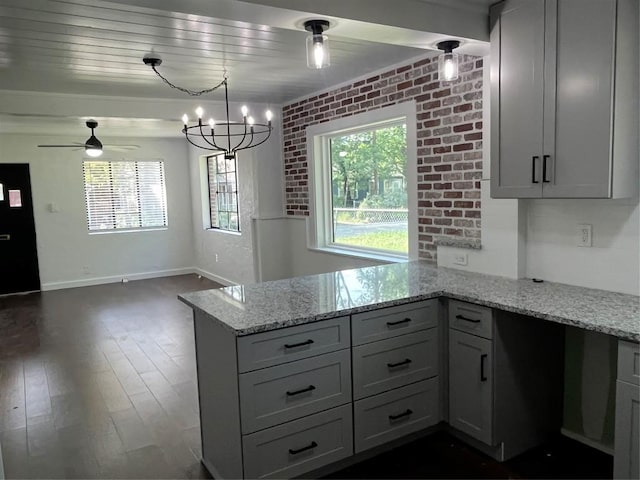 5611 Joe Sayers Ave, Austin, TX 78756 - kitchen with ceiling fan, light stone countertops, freestanding refrigerator, a peninsula, and open floor plan