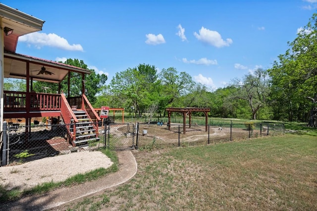 view of yard featuring fence, stairway, a gate, and ceiling fan