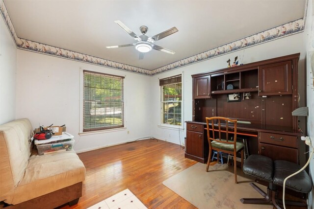 home office featuring wood finished floors and a ceiling fan