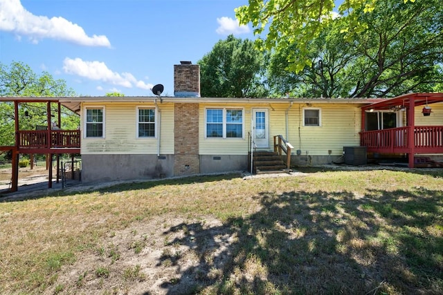 back of house featuring a wooden deck, crawl space, a lawn, central AC, and a chimney